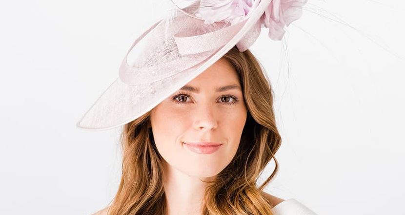 A model wearing a fascinator from Hats & Tiaras