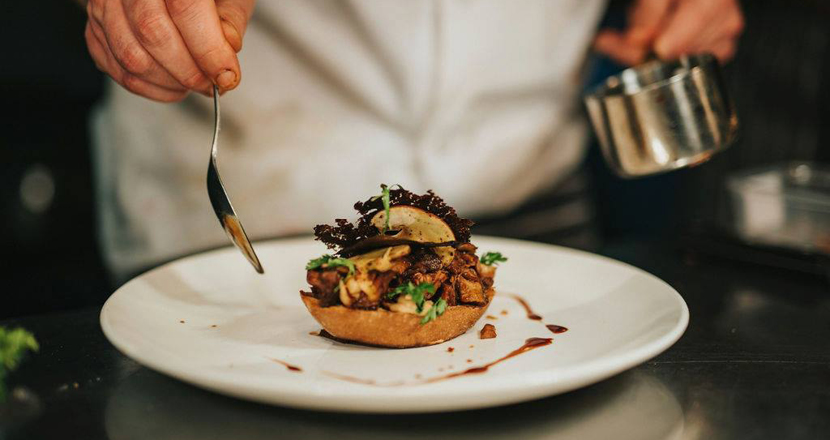 A chef preparing a meal at Healing Manor