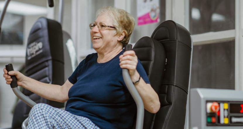 Older lady working out in a gym