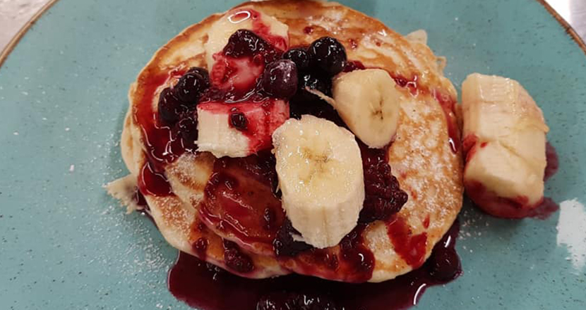 Close up shot of a blueberry and banana pancake