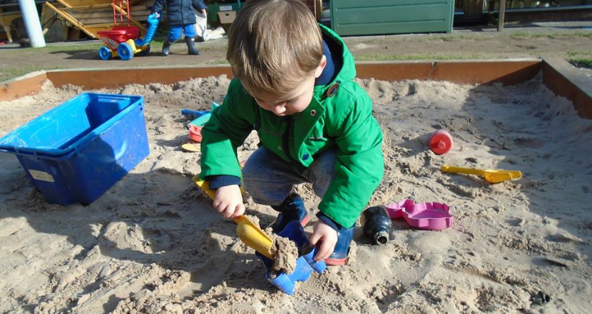 child playing in sand